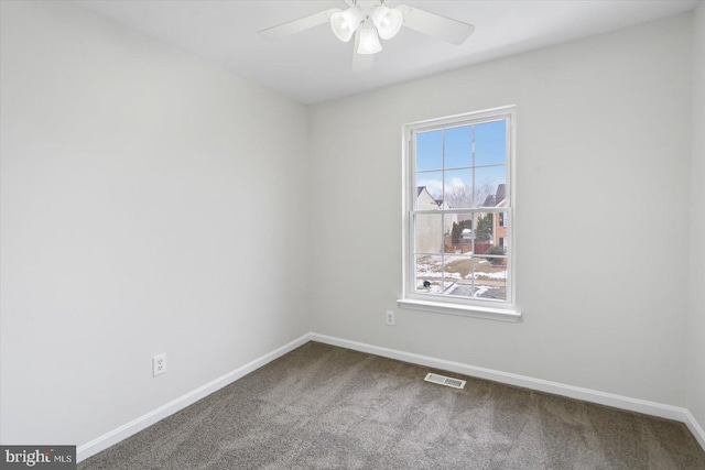 spare room featuring ceiling fan and carpet flooring