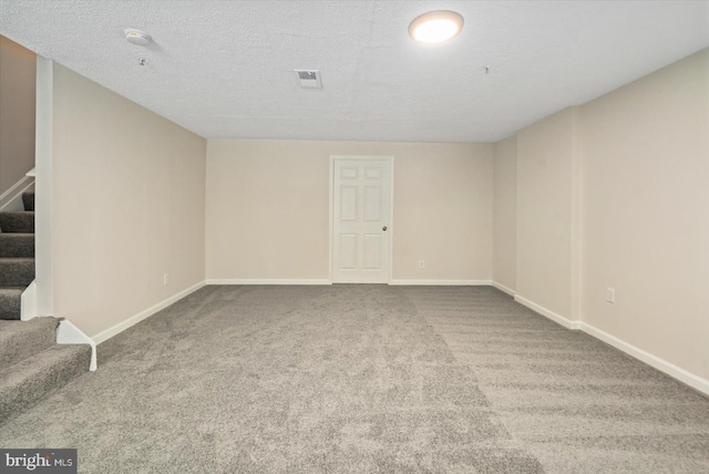 unfurnished room featuring carpet floors and a textured ceiling