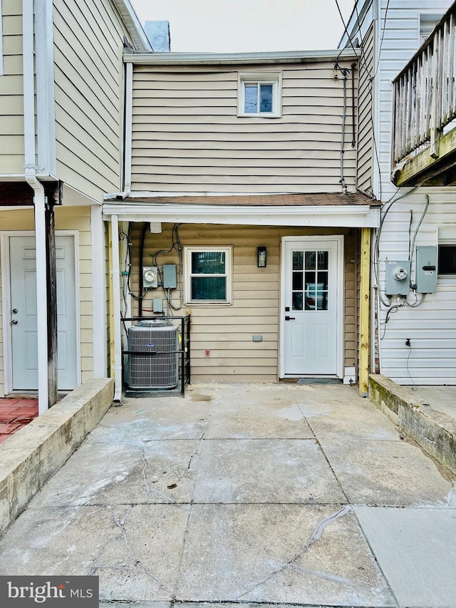 property entrance featuring a patio area and central air condition unit