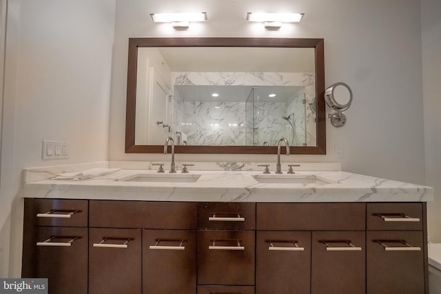 bathroom featuring a shower and vanity