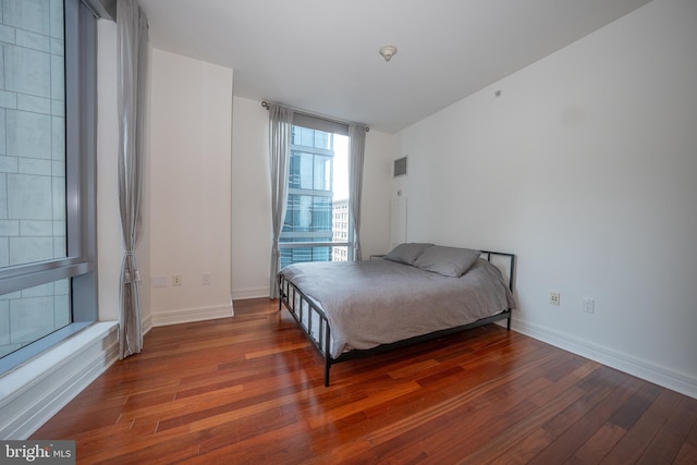 bedroom featuring dark hardwood / wood-style flooring