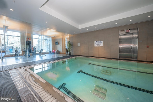 view of pool featuring elevator