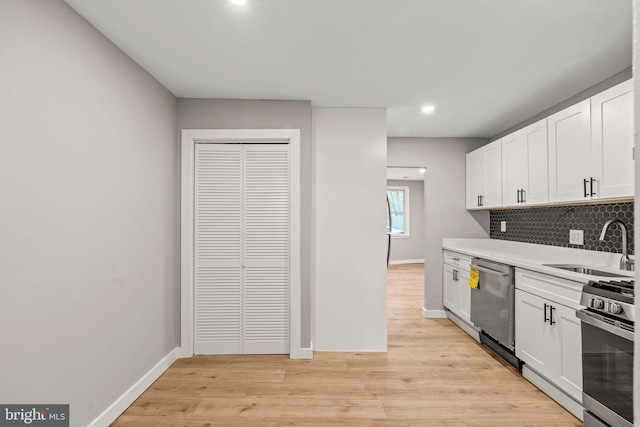 kitchen featuring decorative backsplash, sink, white cabinetry, and stainless steel appliances