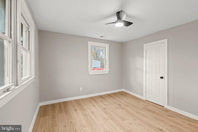 empty room featuring ceiling fan and light hardwood / wood-style flooring