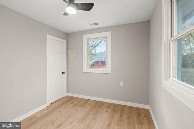 spare room with light wood-type flooring and ceiling fan