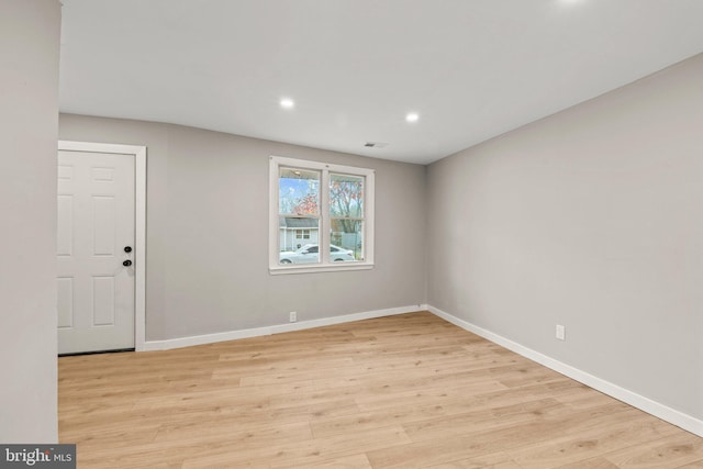 unfurnished room with light hardwood / wood-style floors