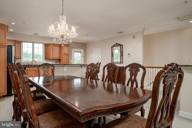 dining space with light tile patterned flooring, ornamental molding, a chandelier, and sink