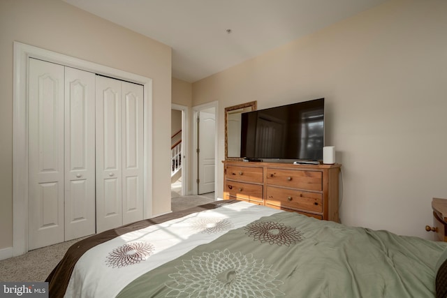 bedroom with light colored carpet and a closet