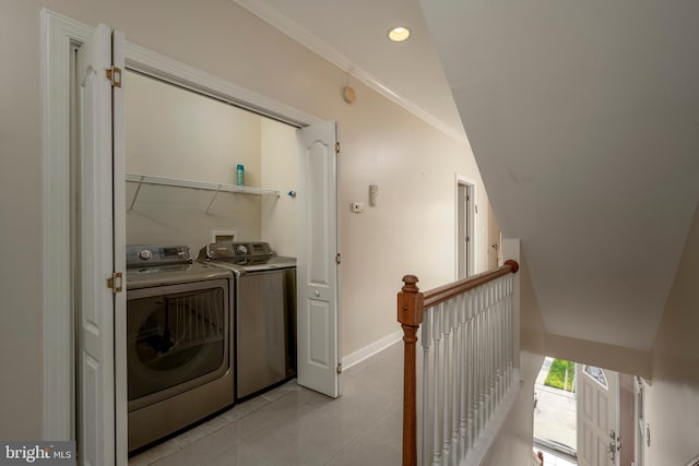 washroom with separate washer and dryer, light tile patterned floors, and crown molding