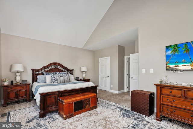 carpeted bedroom with lofted ceiling