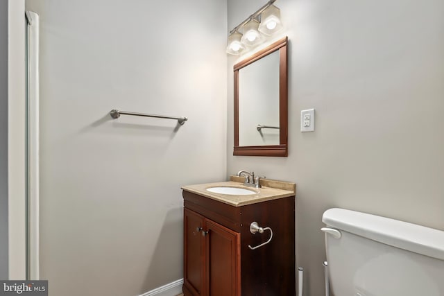 bathroom featuring toilet and vanity