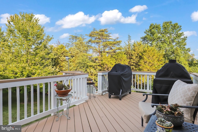 wooden terrace featuring a grill