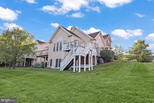 view of side of property featuring a wooden deck and a lawn