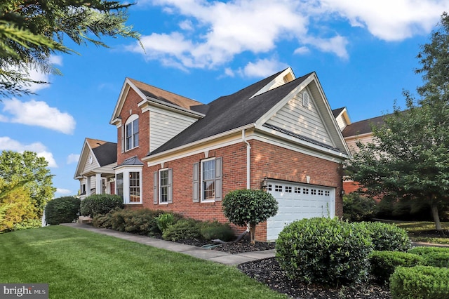 view of side of property featuring a garage and a lawn