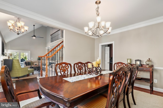 dining room with ceiling fan with notable chandelier, wood-type flooring, french doors, ornamental molding, and vaulted ceiling