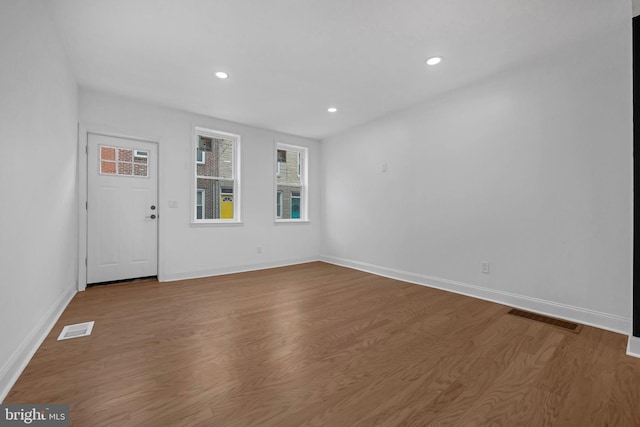 empty room with hardwood / wood-style floors