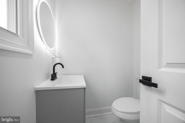 bathroom with toilet and vanity