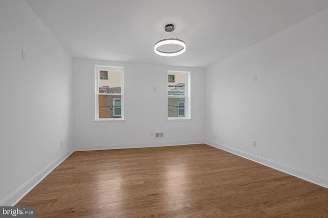 unfurnished room with wood-type flooring