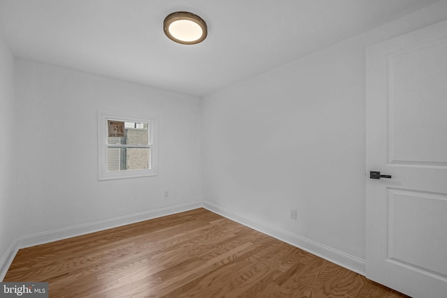 unfurnished room with hardwood / wood-style flooring