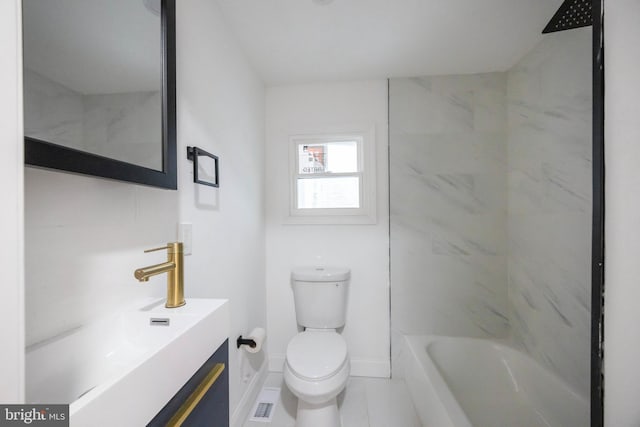 full bathroom featuring toilet, tiled shower / bath combo, and vanity