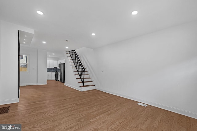 unfurnished living room featuring light hardwood / wood-style floors