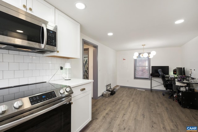 kitchen with white cabinets, backsplash, an inviting chandelier, and stainless steel appliances