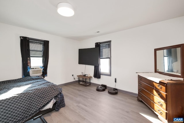 bedroom featuring cooling unit and light wood-type flooring