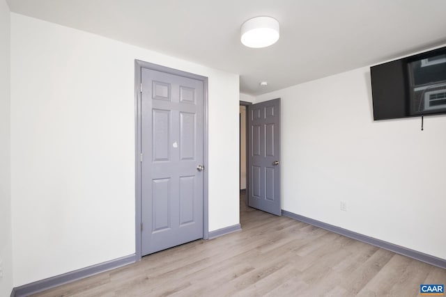 unfurnished bedroom featuring light wood-type flooring