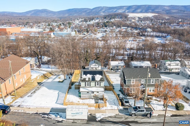 snowy aerial view featuring a mountain view