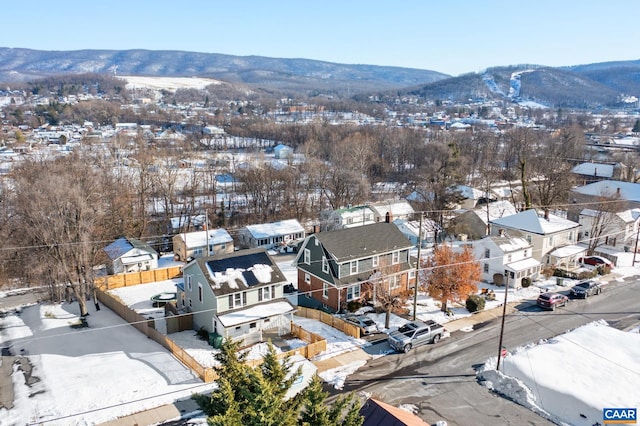 snowy aerial view featuring a mountain view