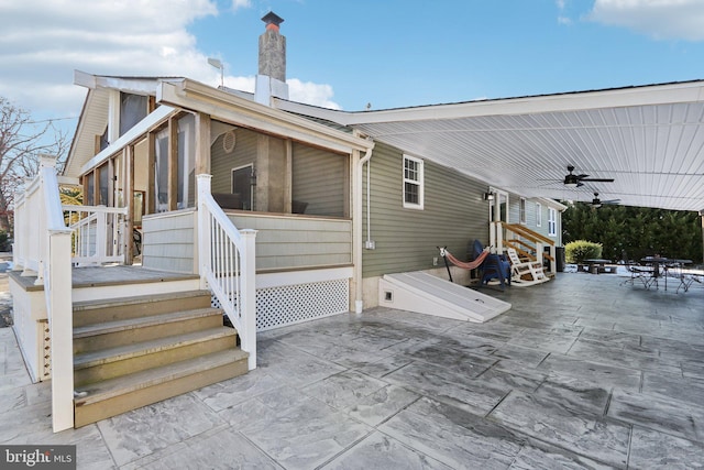 exterior space featuring ceiling fan and a sunroom