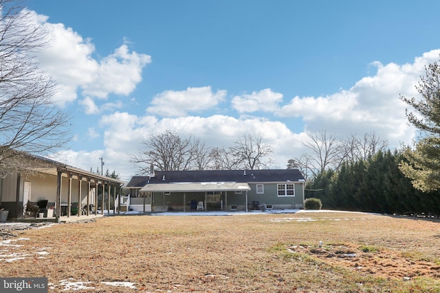 back of property with a patio area and a yard