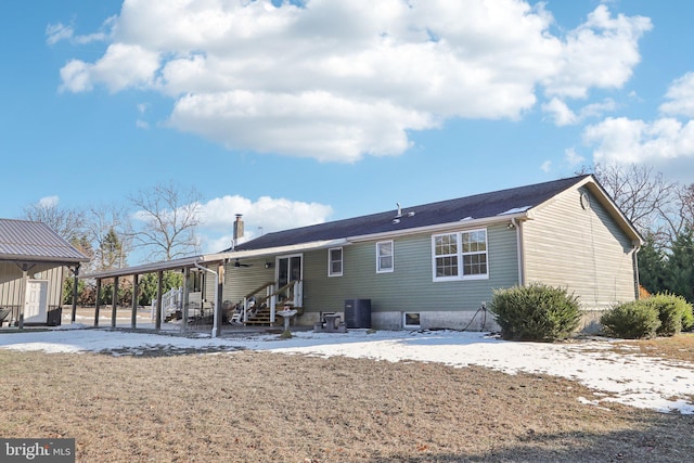 back of property featuring a carport and central air condition unit