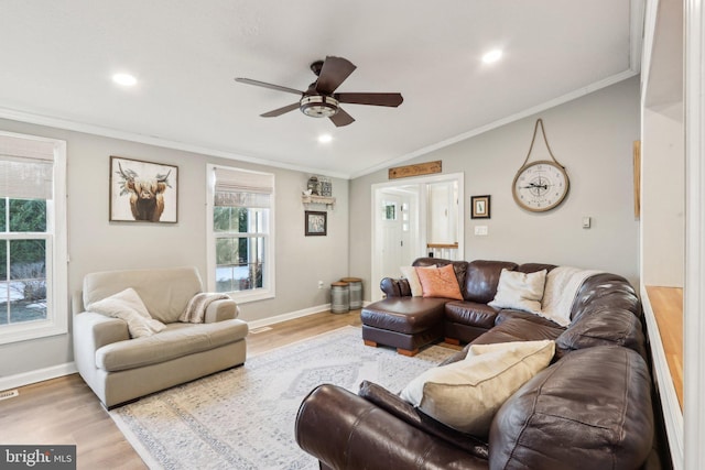 living room featuring ceiling fan, hardwood / wood-style floors, crown molding, and vaulted ceiling