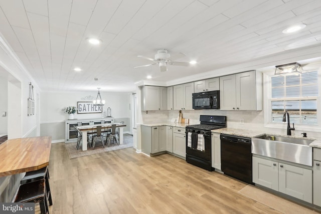 kitchen with ceiling fan, gray cabinetry, decorative light fixtures, black appliances, and sink