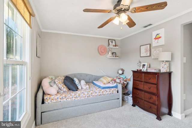 bedroom with ceiling fan, crown molding, and light colored carpet