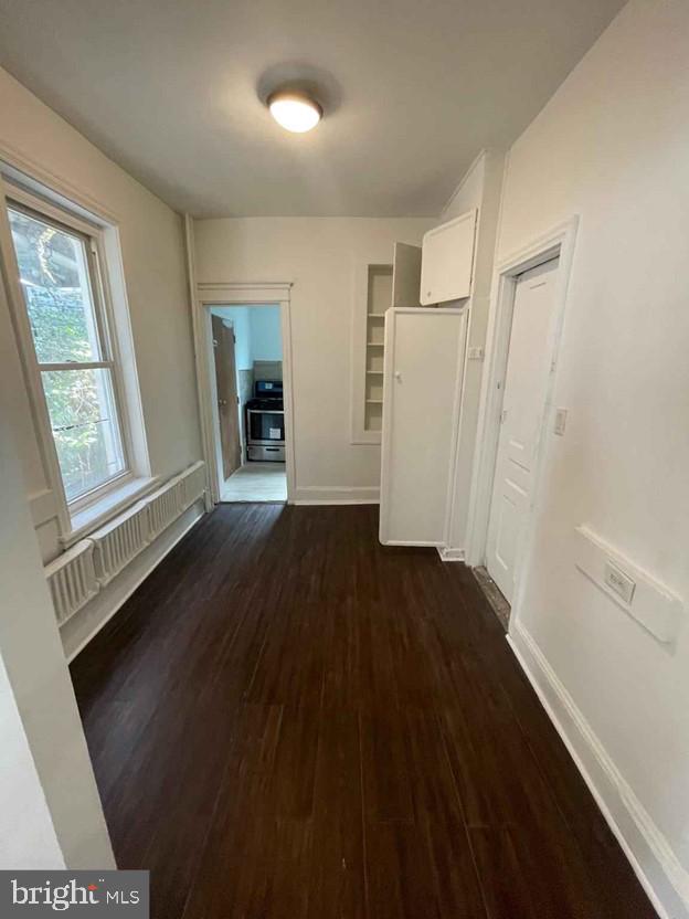 hallway featuring dark hardwood / wood-style floors