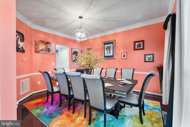 dining space with crown molding and a chandelier