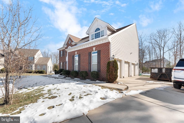 view of snow covered exterior with a garage