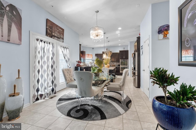 tiled dining room featuring a chandelier