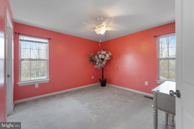 carpeted empty room featuring ceiling fan