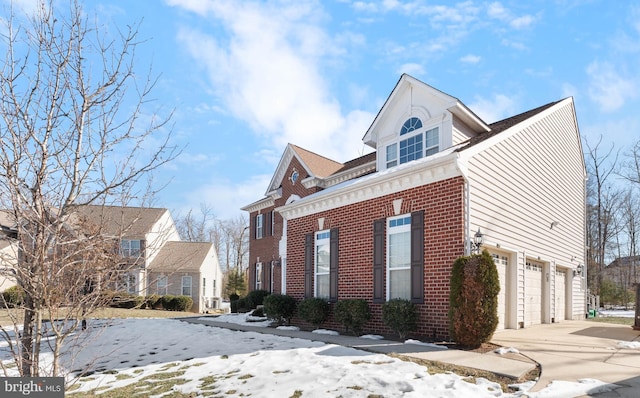 view of snow covered exterior featuring a garage