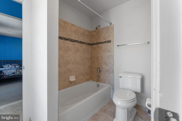 bathroom featuring tile patterned flooring, bathtub / shower combination, and toilet