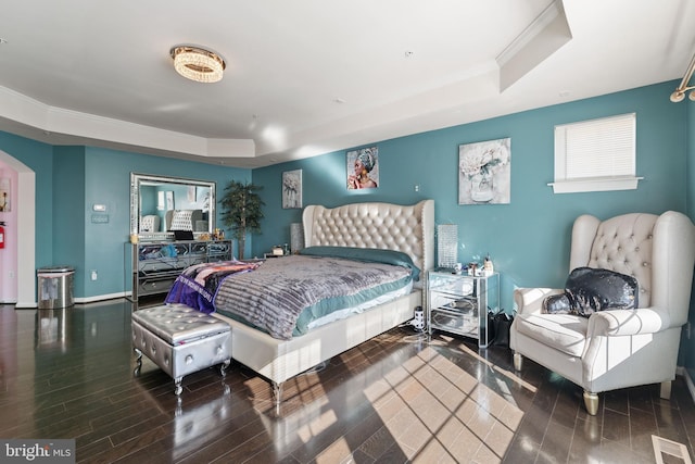 bedroom with crown molding and a tray ceiling