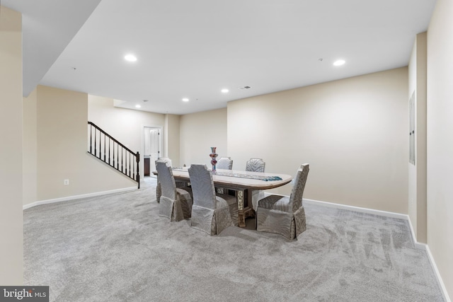 dining area with light colored carpet