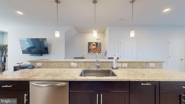 kitchen featuring stainless steel dishwasher, sink, and dark brown cabinets