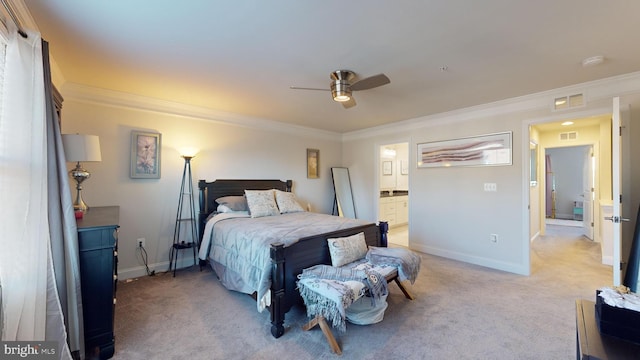 carpeted bedroom with crown molding, ensuite bath, and ceiling fan