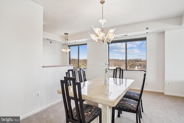 dining area featuring carpet floors, plenty of natural light, and baseboards