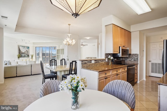 kitchen with light tile patterned floors, visible vents, appliances with stainless steel finishes, backsplash, and dark stone countertops