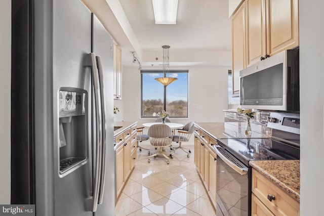 kitchen with light stone counters, light tile patterned flooring, hanging light fixtures, appliances with stainless steel finishes, and light brown cabinetry